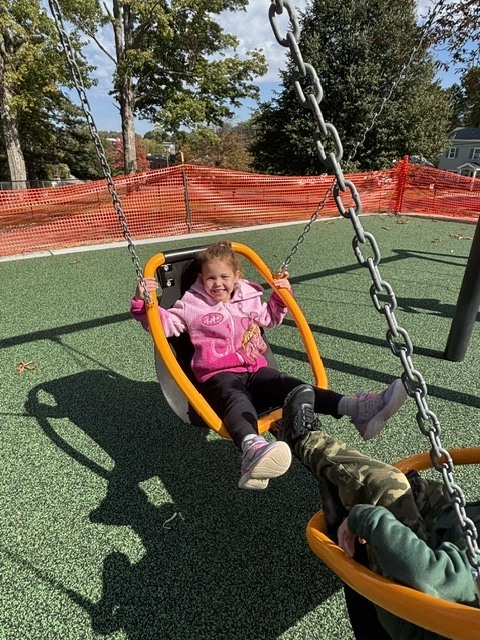 Wheelock students play on various pieces of equipment on the new Main St. playground.