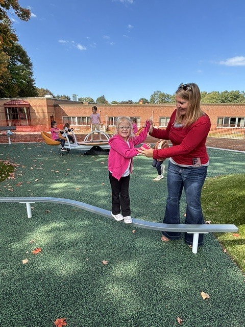 Wheelock students play on various pieces of equipment on the new Main St. playground.