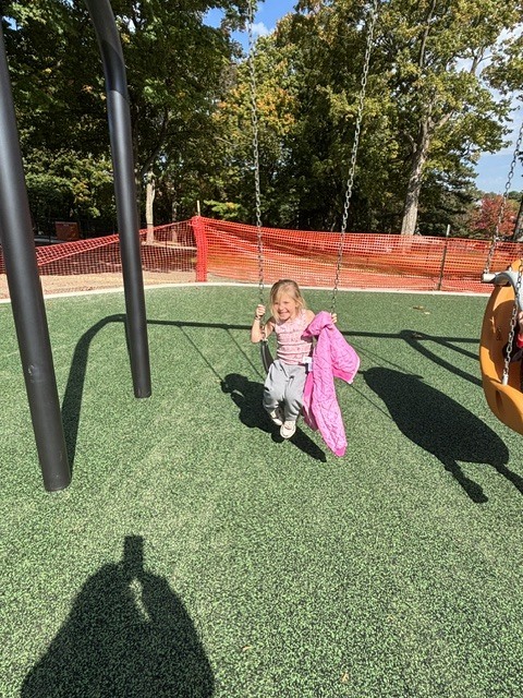 Wheelock students play on various pieces of equipment on the new Main St. playground.