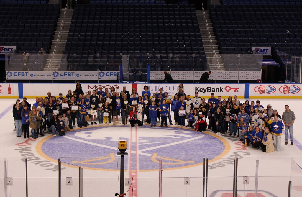 Members of Fredonia CSD & their friends/families pose at center ice at Key Bank Arena