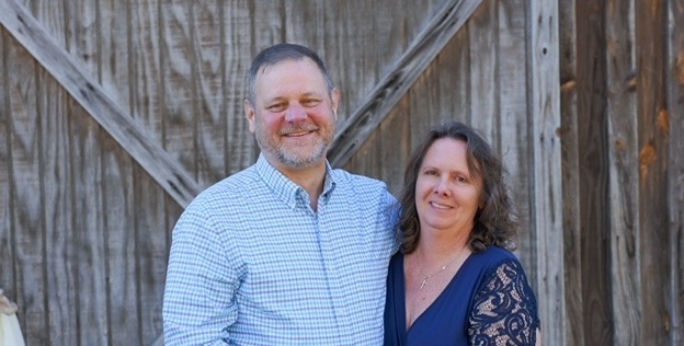 Man and woman hold hands and smile