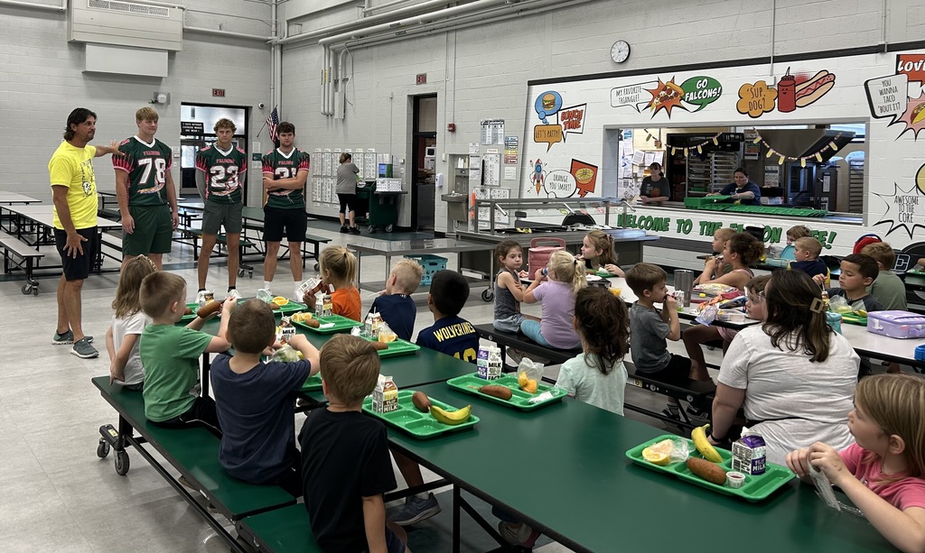 Football players visit the Freeland Learning Center. 