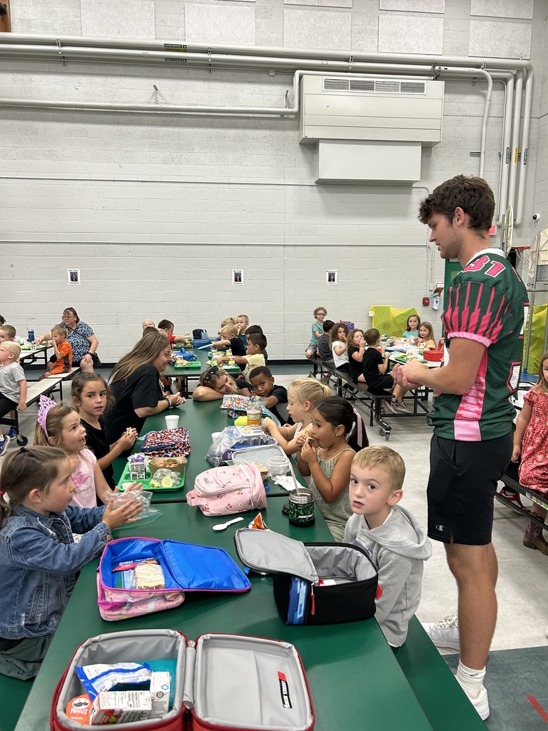 Football player helps in a cafeteria. 