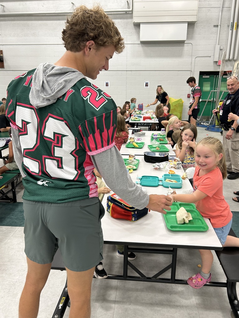 Football player helping a child. 