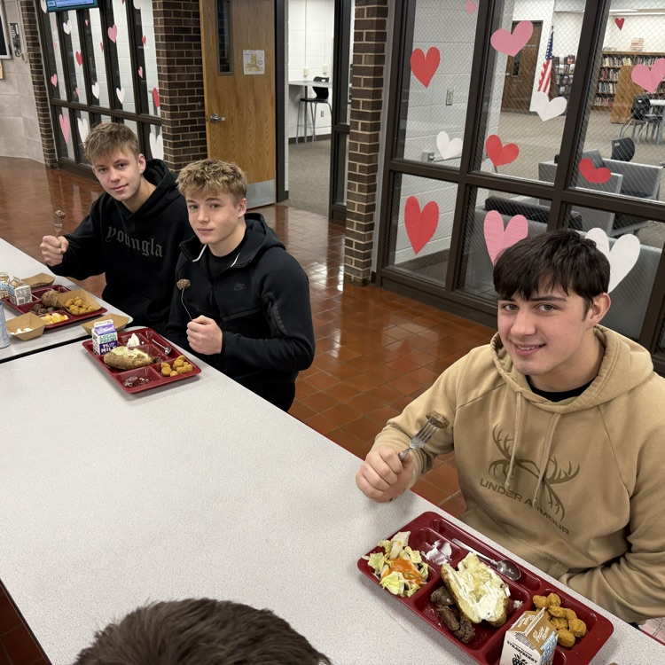 HS boys eating steak