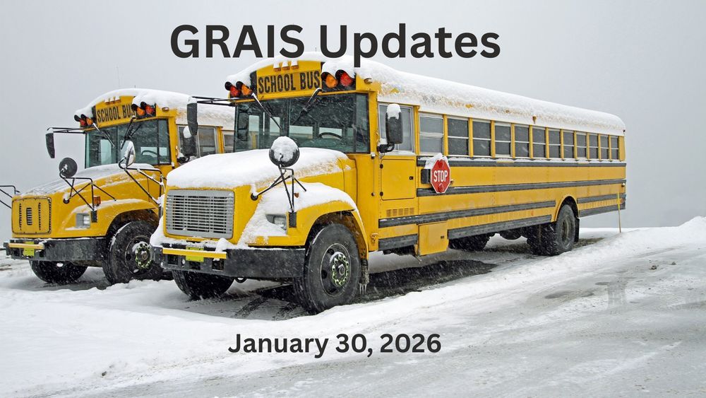 two school buses covered in snow.