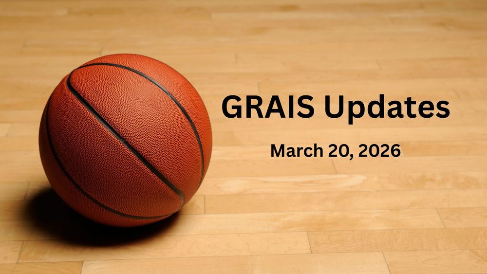 A basketball on a wooden floor.