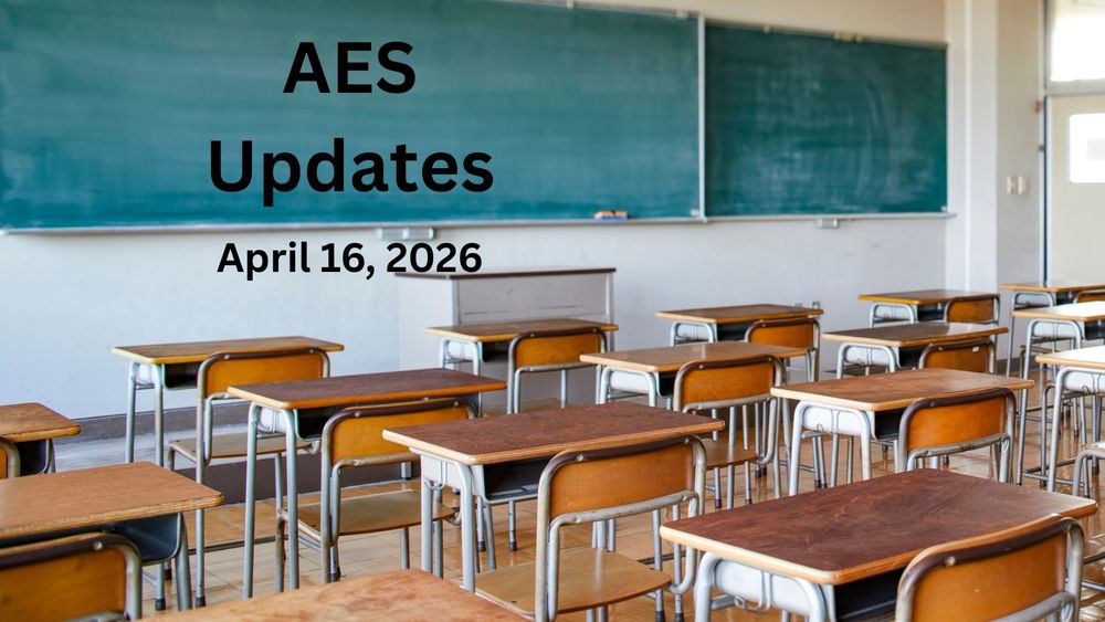 An empty classroom with wooden desks and chairs.