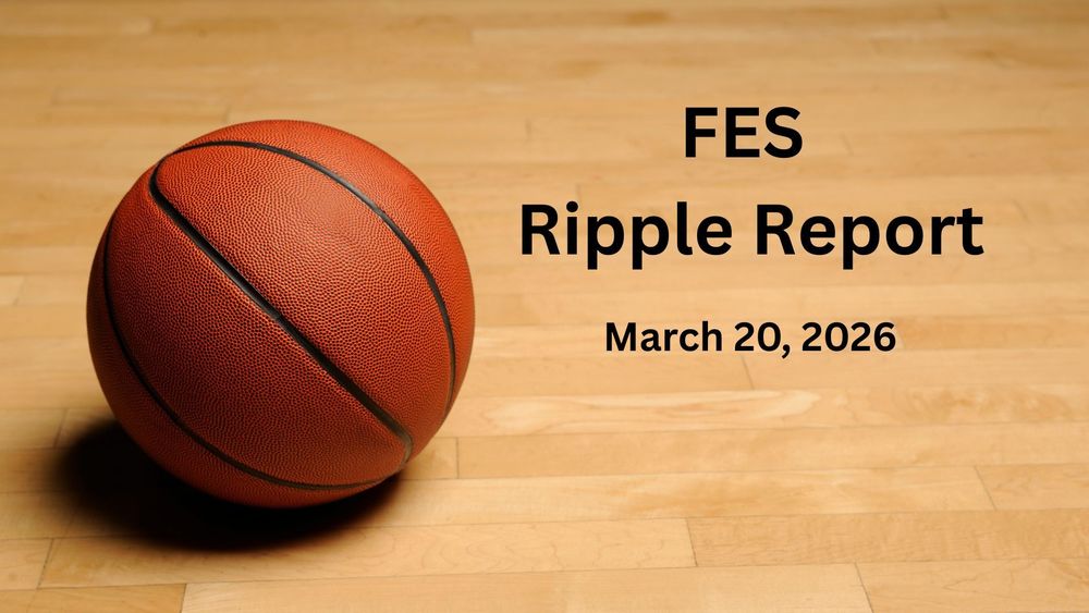 A basketball on a wooden floor.