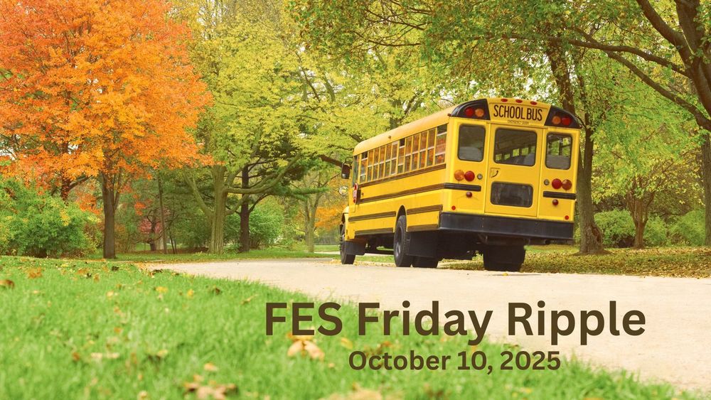 A school bus along a road with color changing trees.