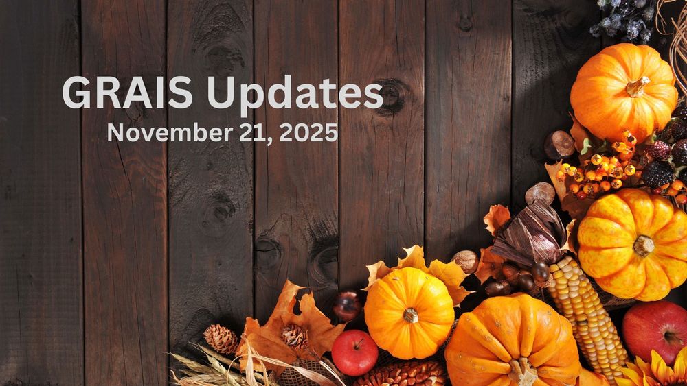 Pumpkins, berries, apples and autumn leaves against a wooden background.