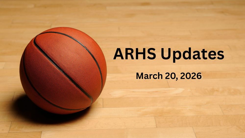 A basketball on a wooden floor.