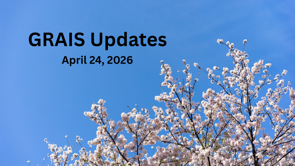 Cherry blossom branches in bloom against  a blue sky.