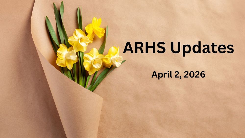 Five yellow dandelions wrapped in brown paper. 