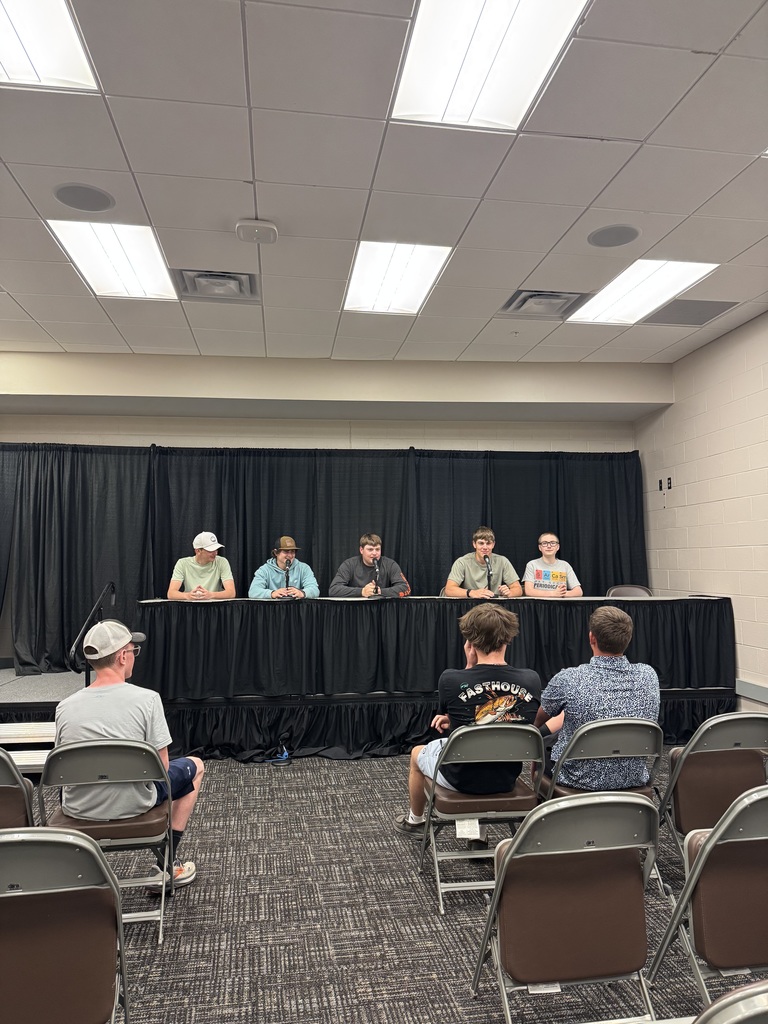 Students sitting on a panel on Omaha field trip