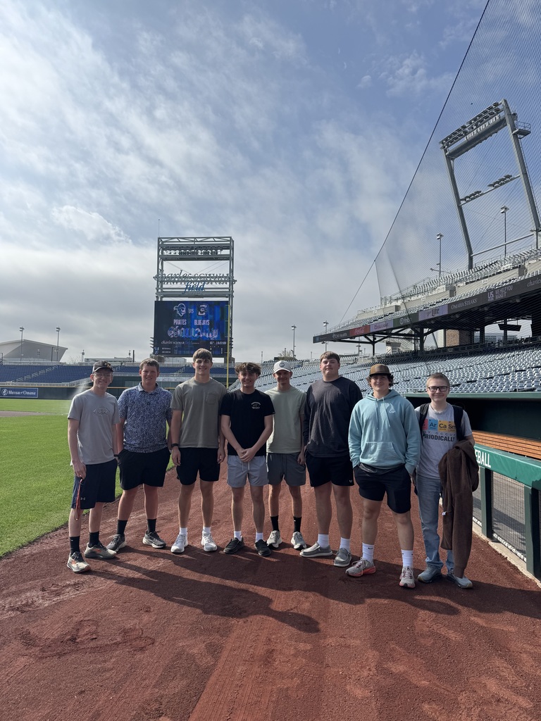 Students standing on baseball field in Omaha