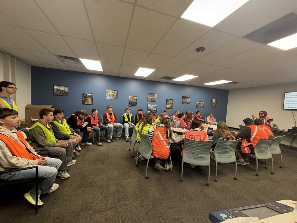 Students listening to a presentation from Goodwill's Marketing team