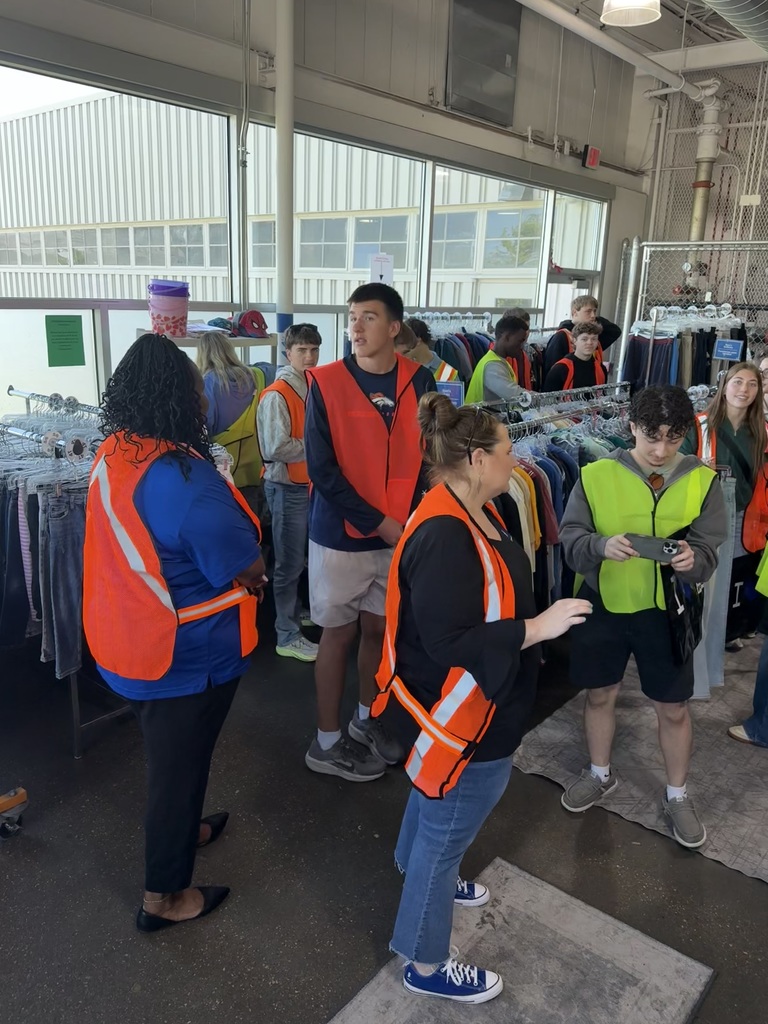 Students exploring behind the scenes in a Goodwill warehouse