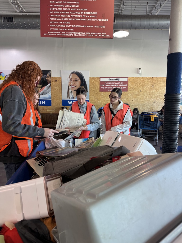 Students looking through materials at Goodwill