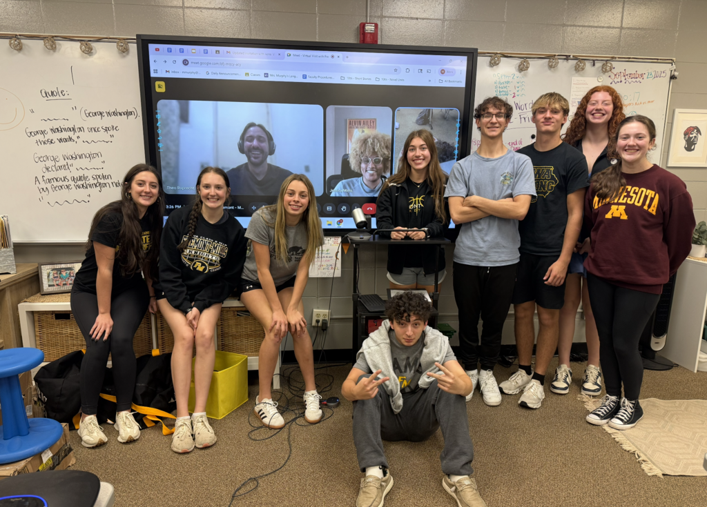 students smiling with a guest speaker who presented over Zoom