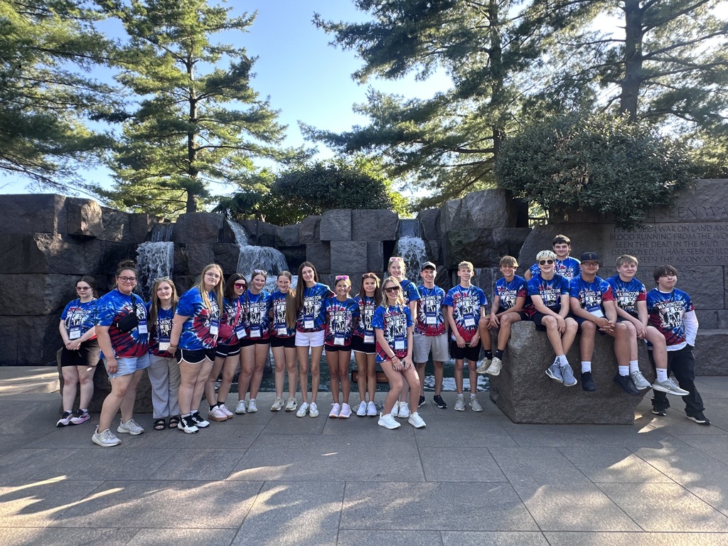 Students posing in front of a water fountain