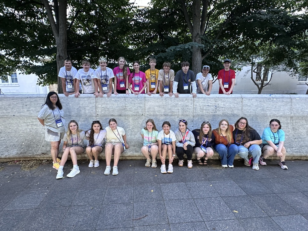Students posing on the sidewalk
