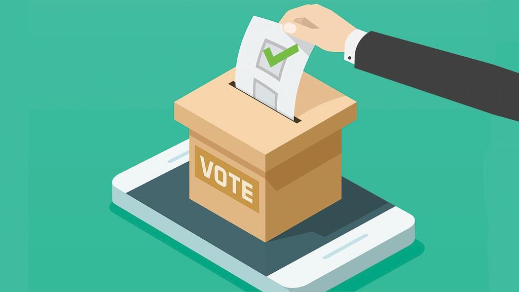 picture of a hand voting in a ballot box