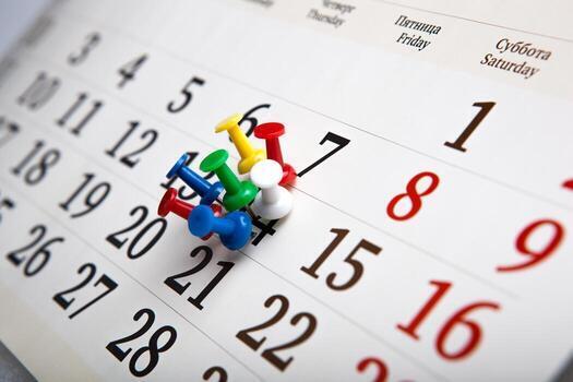 a picture of a calendar with thumbtacks in the calendar 