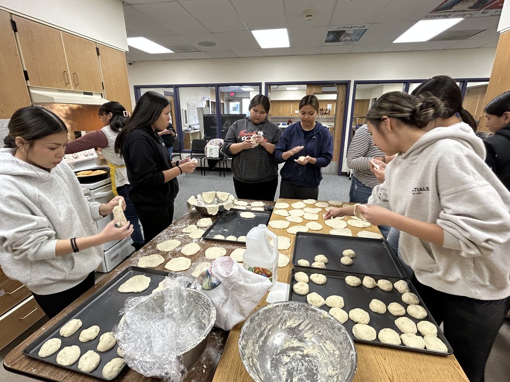 Multicultural Club students making fry bread