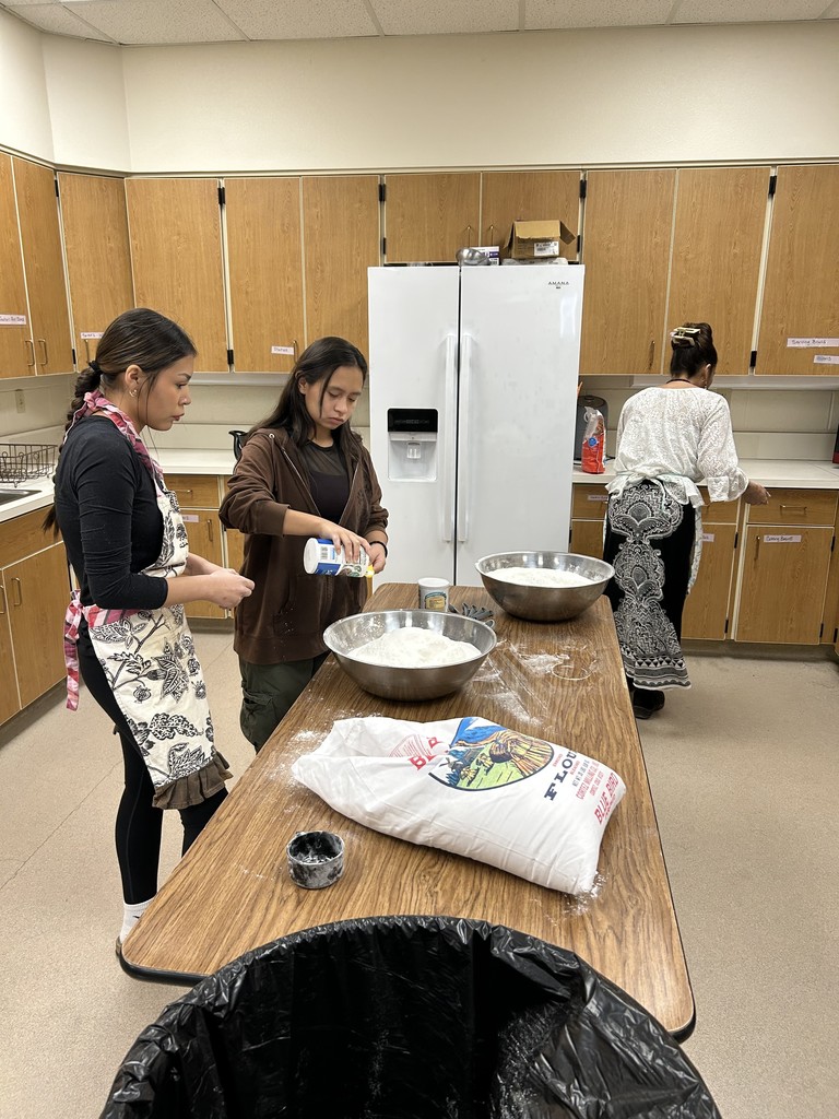 Natiya, Emerald, and Ellie making fry bread