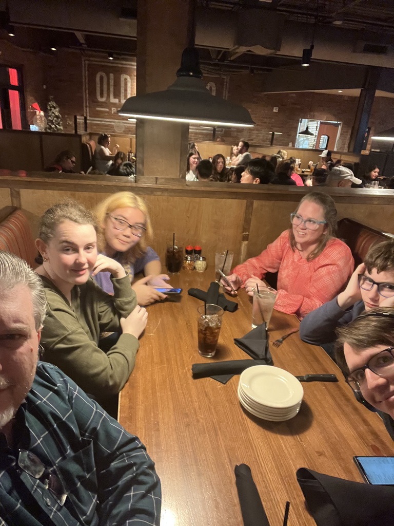 Some tired people. After a day of rehearsal, it was nice to sit down to some tasty pizza.