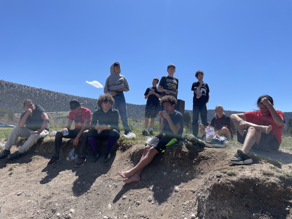 Students having lunch by the lake.