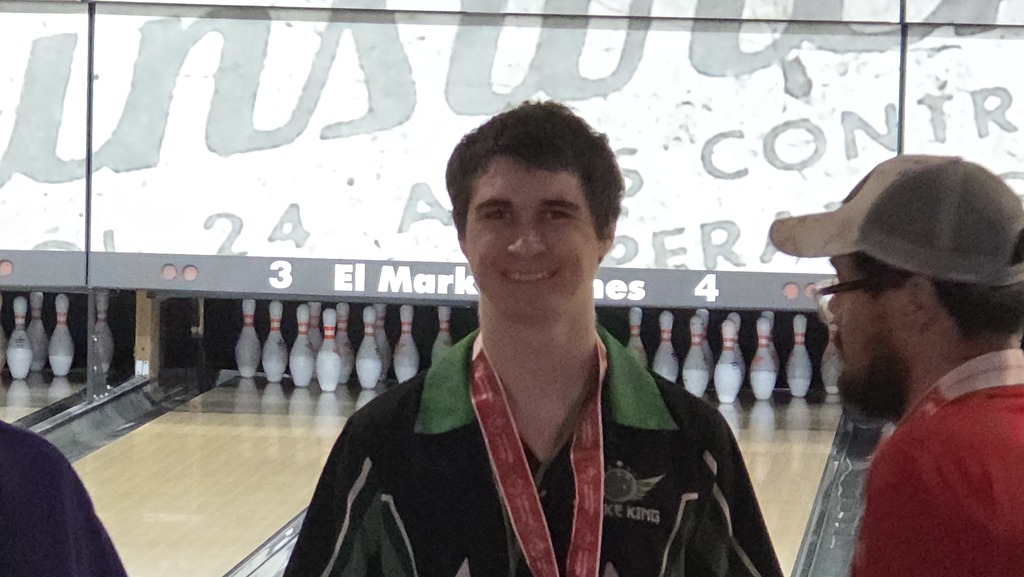 Damasus with his bronze medal for Special Olympics Bowling