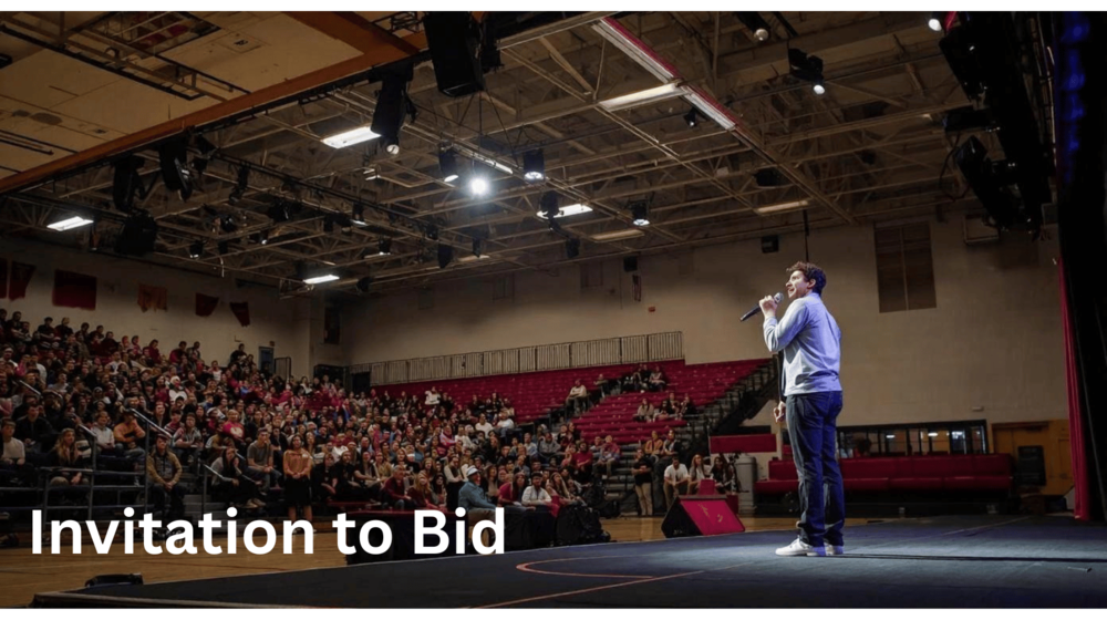 person with microphone standing in hs gym in front of student body in bleachers
