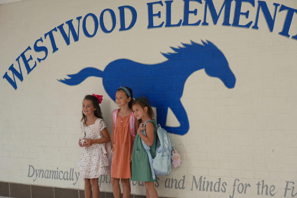 three students smiling 