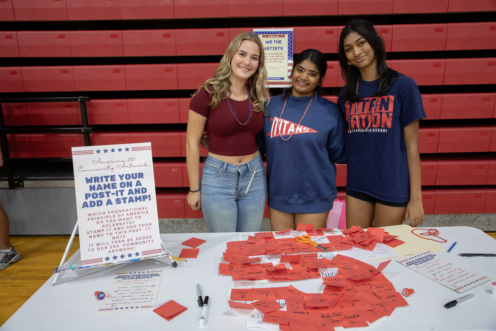 Three students at the Centennial America 250 celebration.