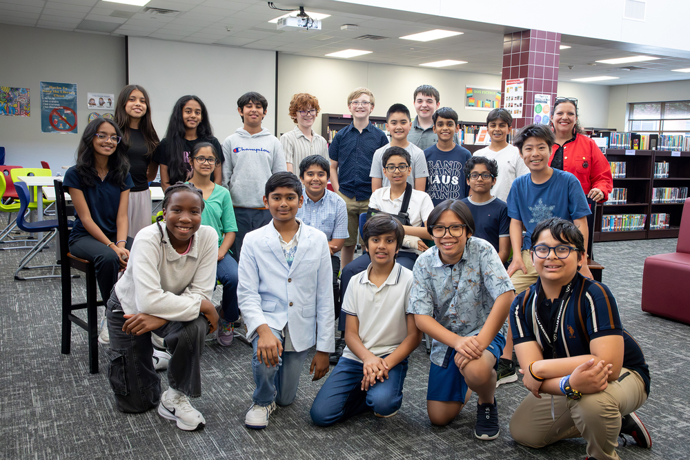 A group of students posing in a library
