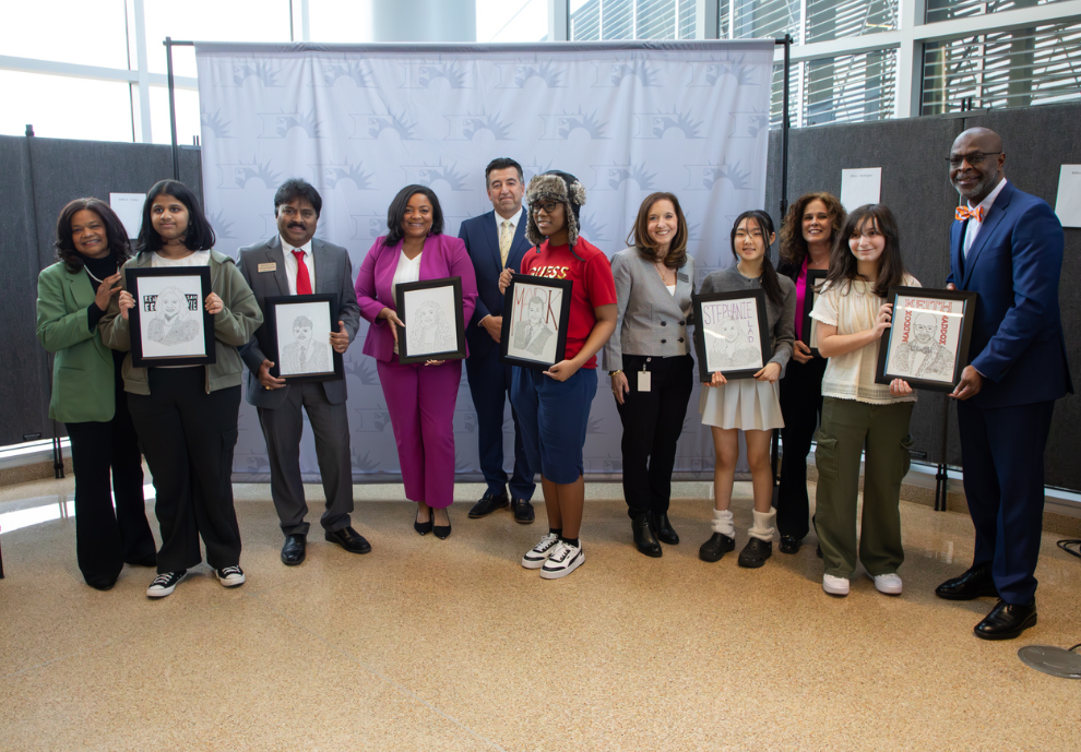Board members and students holding portraits