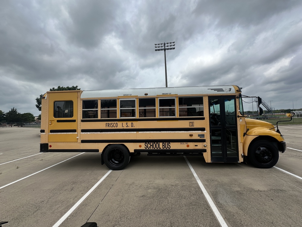A yellow school bus in a parking lot