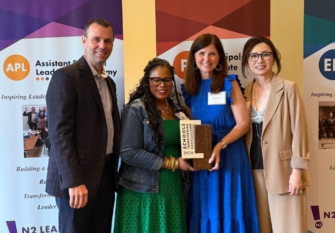 Four people holding an award
