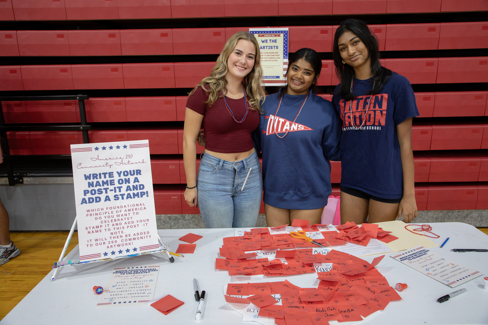 Three students at the Centennial America 250 celebration.
