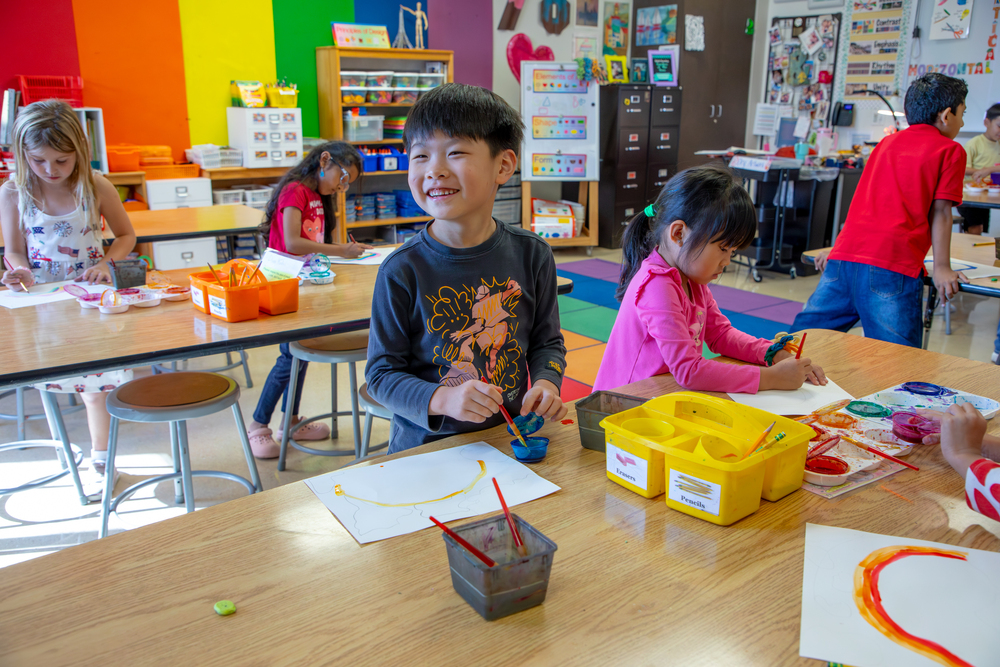 Boy smiling in colorful art classroom
