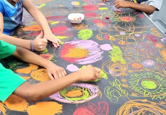 Children using chalk on a blackboard