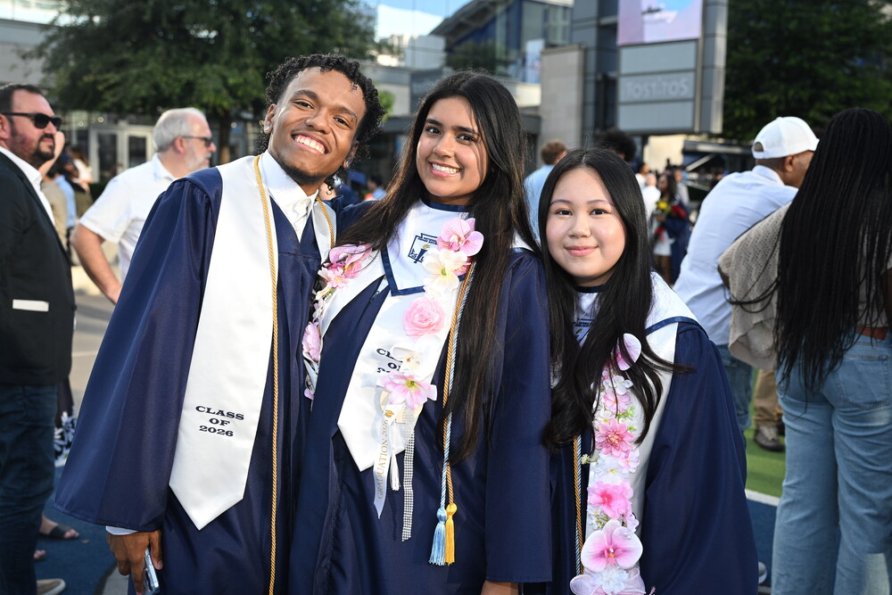 Three students posing in their graduation gowns