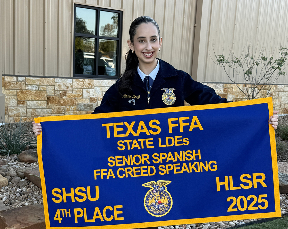 Girl holding a banner for Texas FFA