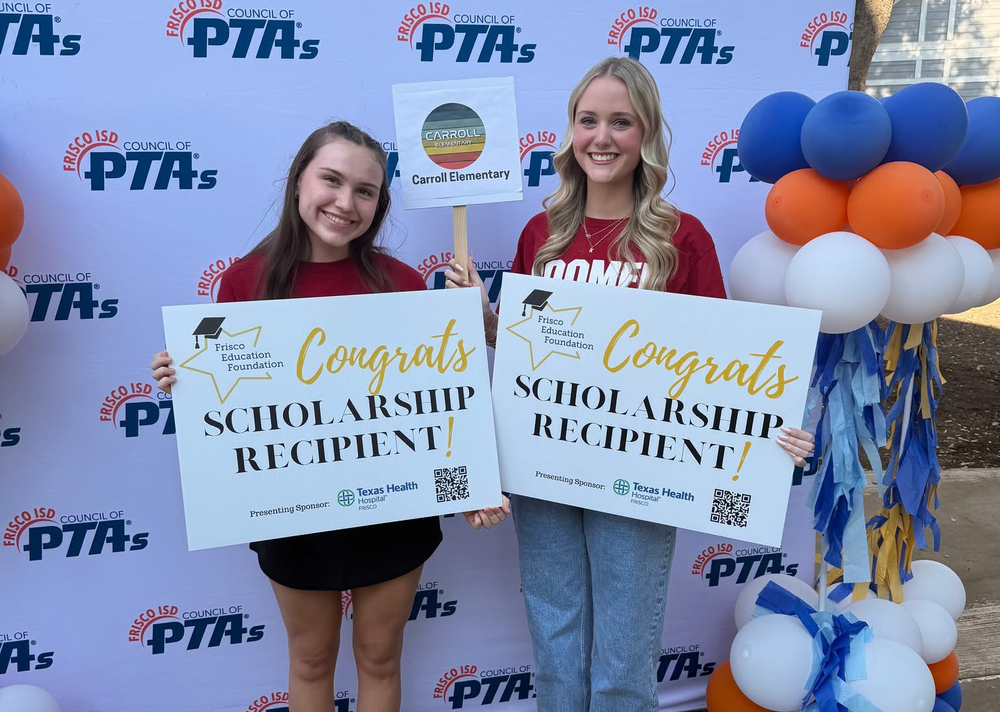 Two girls holding signs that say Congrats Scholarship Recipient