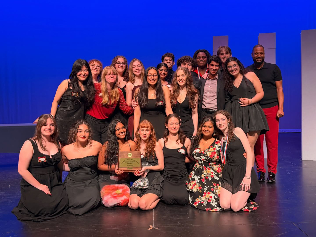 Group of theater students holding a plaque