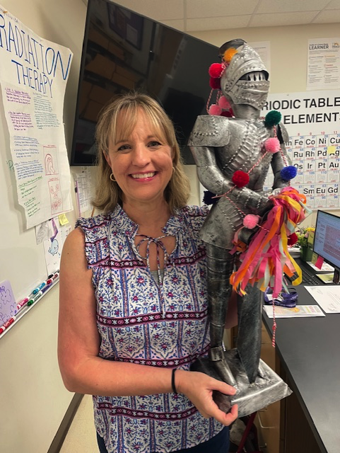 teacher holding a trophy