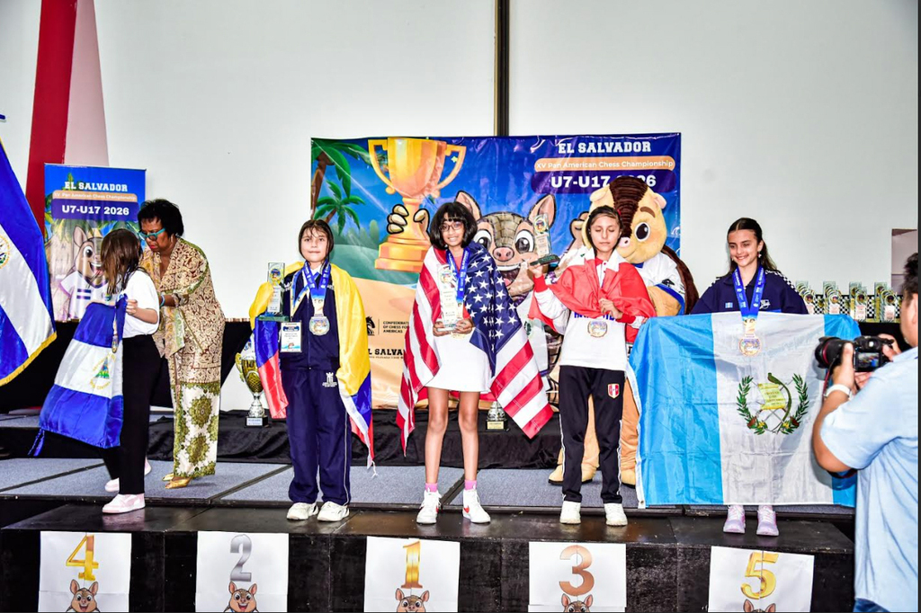 Children standing on a stage in celebration