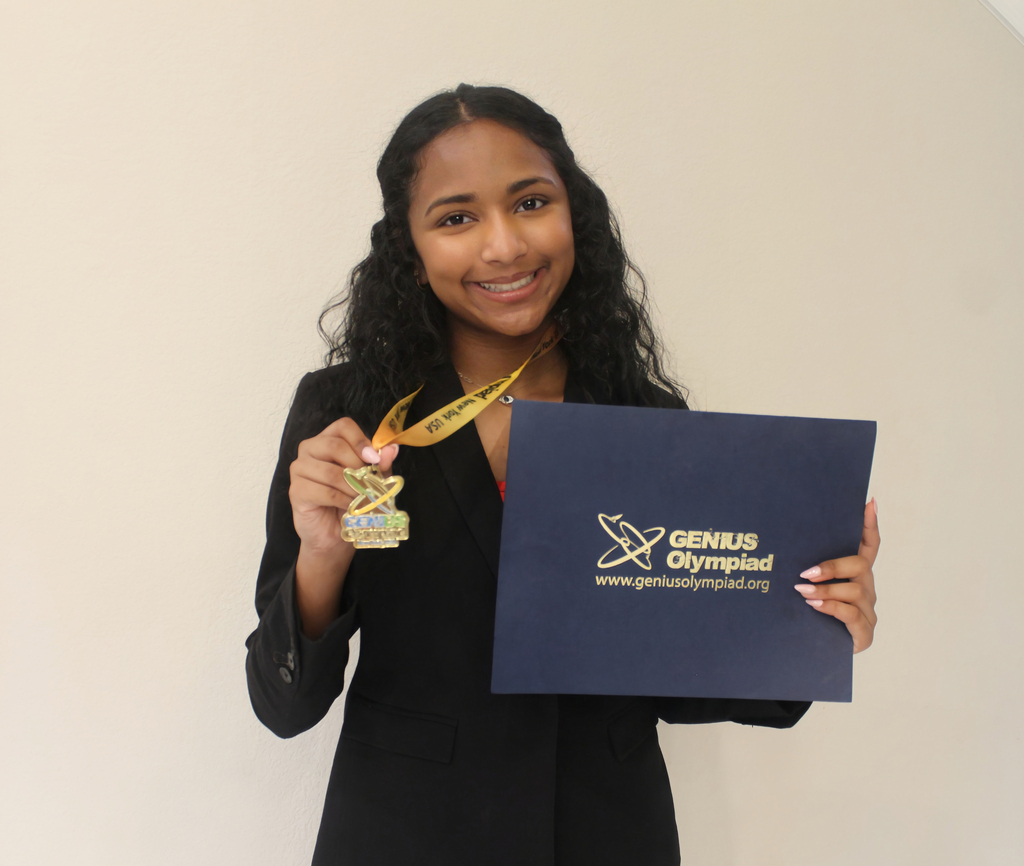 A girl holding a gold medal